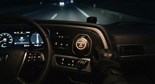 Backlit industrial panic button mounted on a truck dashboard